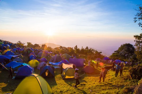 Tourist enjoying sunrise on mountain with camping — Stock Photo, Image