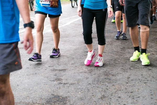Running feet on the road during marathon running — Stock Photo, Image