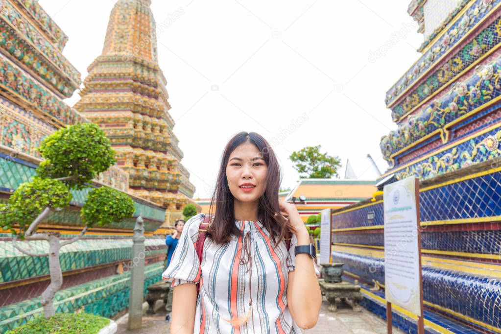 Tourist asian women walking in buddhist temple in Bangkok