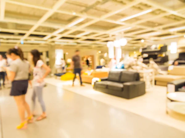 Abstract motion blurred people shopping in furniture store — Stock Photo, Image