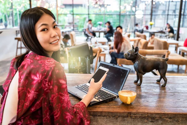 Business asian women using laptop drink coffee