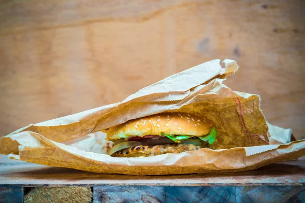 Good tasty homemade hamburger with vegetable in brown box