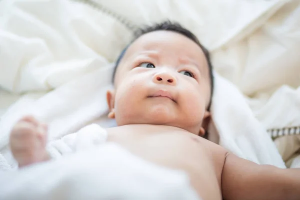 Niño bebé acostado sobre una manta blanca — Foto de Stock