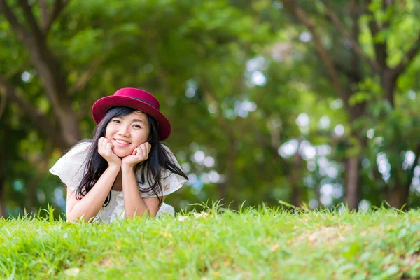 Joyful beautiful women relaxation lying on grass — ストック写真