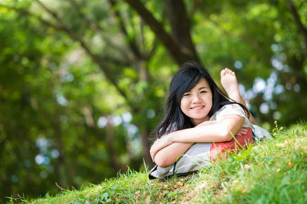 Freudig schöne Frauen entspannen sich im Gras liegend lizenzfreie Stockfotos