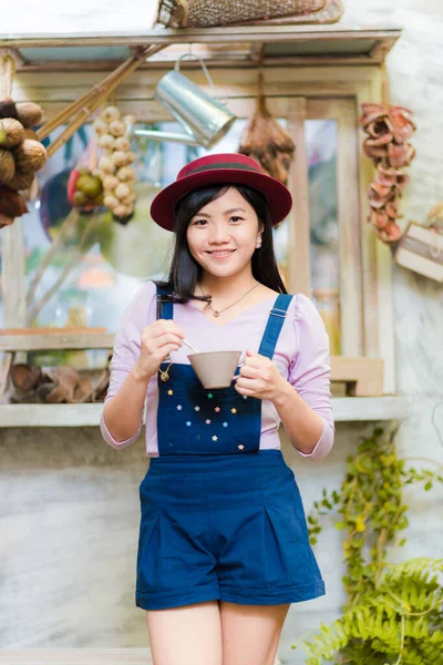 Beautiful asian women hold hot latte coffee