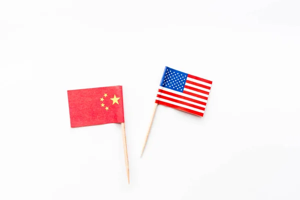 Creative top view flat lay of China and USA flag, mockup and copy space on white background in minimal style. Concept of trade war between USA and China