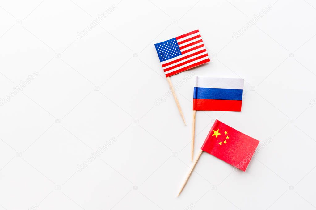 Creative top view flat lay of China, Russia and USA flags on white background in minimal style. 
