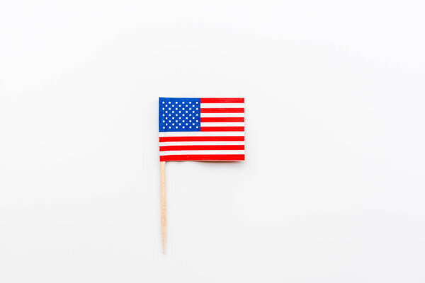 Happy Independence Day 4th july with mini USA flag lying on white background. Top view. Mock up, overhead, flatlay. Memorial Day.