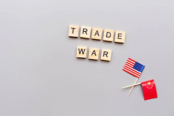 Creative top view flat lay of China and USA flags, mockup and copy space on gray background in minimal style. Concept of trade war between USA and China