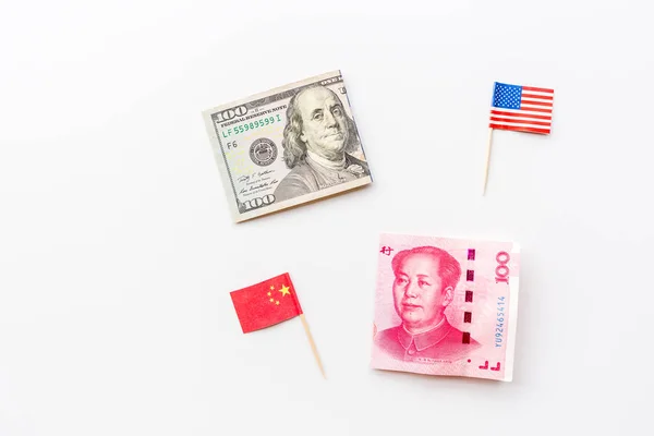 Creative top view flat lay of USA and China flags and cash money, mockup and copy space on white background in minimal style. Concept of trade war between USA and China
