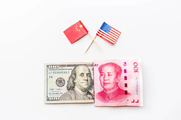 Creative top view flat lay of USA and China flags and cash money, mockup and copy space on white background in minimal style. Concept of trade war between USA and China