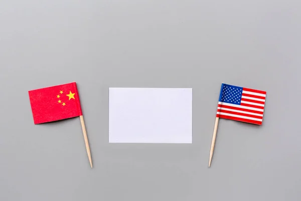 Creative top view flat lay of China and USA flags, mockup and copy space on gray background in minimal style. Concept of trade war between USA and China — Stock Photo, Image