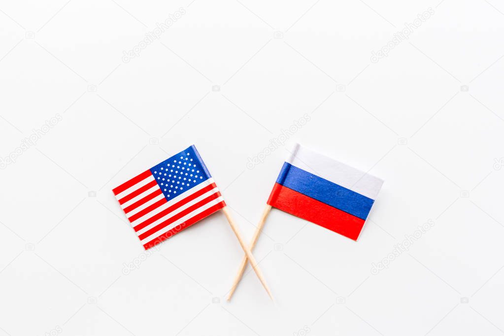 Creative top view flat lay of USA and Russia flags, mockup and copy space on white background in minimal style. Concept fight, war, business competition