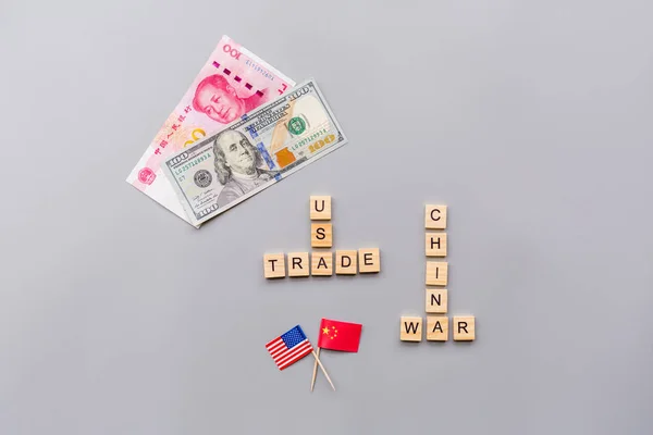 Creative top view flat lay of China and USA flags and cash money, mockup and copy space on gray background in minimal style. Concept of trade war between USA and China