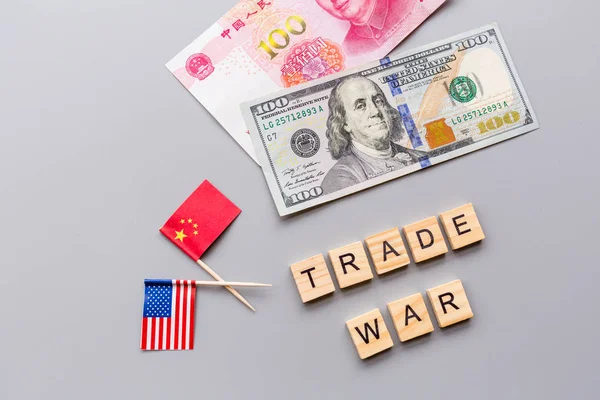 Creative top view flat lay of China and USA flags and cash money, mockup and copy space on gray background in minimal style. Concept of trade war between USA and China