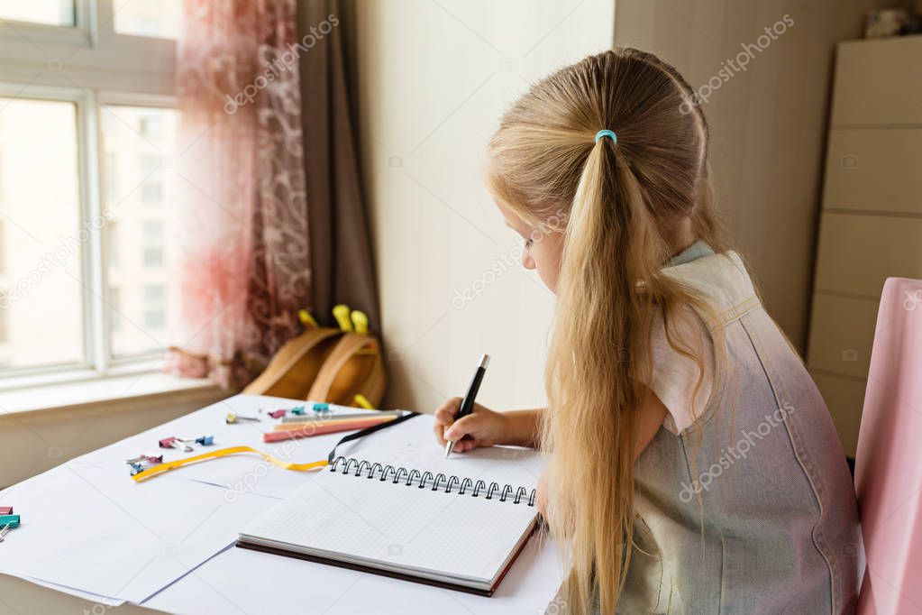 Back to school and happy time. Children holding pen and writting in notebook. Kid making homework. education concept