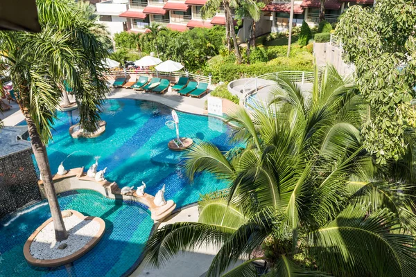 resting area in the tropical hotel, view from balcony. sun deck of resort. Swimming pool view and palm trees. take a rest time concept.