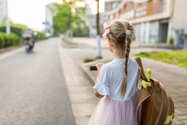 Kid Girl elev bakifrån gå tillbaka till hemmet efter lärande studie skola ensam med Schoolbag, förskola och dagis utbildning koncept. Första höstdagen — Stockfoto