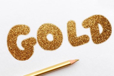 Beyaz defter üzerinde kelime altın. Noel planlama konsepti taklit. Metin düz yatıyordu, üst görünüm için yer