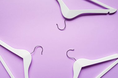 Beyaz ahşap askılar menekşe renginde. Moda kadınsı blog satış mağazası tanıtım tasarımı alışveriş konsepti. Düz yatış, üst görünüm, model, genel giderler