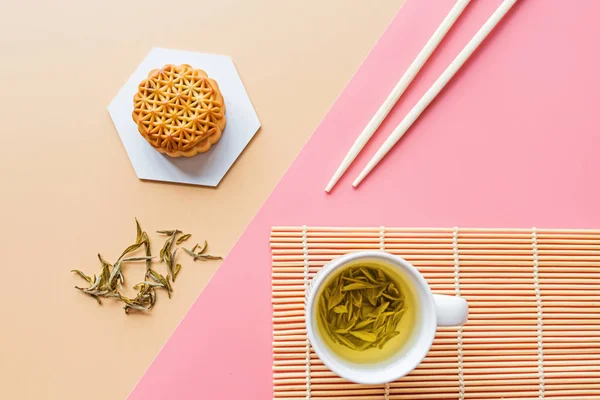 Flat lay of Chinese Festival dessert, Mid Autumn Festival Moon cake on colorful background with green tea and chopsticks. Top view, copy space, mockup, overhead, template — Stock Photo, Image