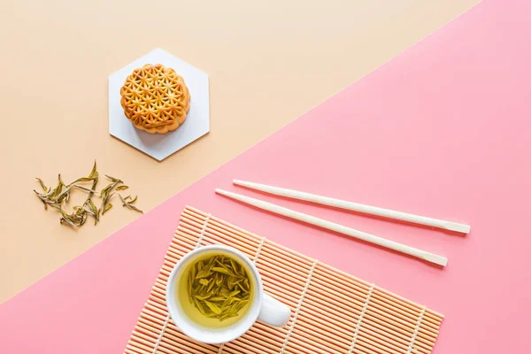 Flat lay of Chinese Festival dessert, Mid Autumn Festival Moon cake on colorful background with green tea and chopsticks. Top view, copy space, mockup, overhead, template — Stock Photo, Image