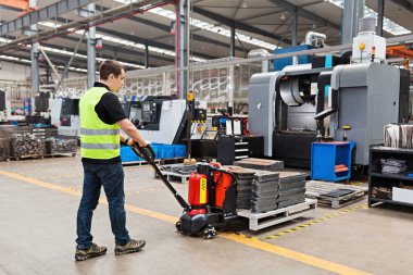 Depo işçisi palet taşıyan el arabası ya da yük paleti boşaltılan el yapımı forklift kullanıyor. Dağıtım, Lojistik İthalat İhracat, Ticaret, Sevkiyat, Teslimat konsepti