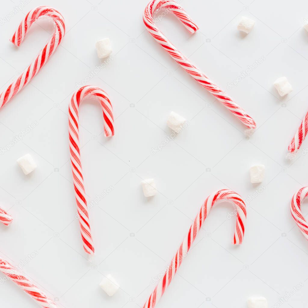 Christmas composition. lollipop canes and marshmallows on white. new year concept. Square Greeting card, winter holidays, xmas celebration 2020. Flat lay, top view, copy space, mockup, template