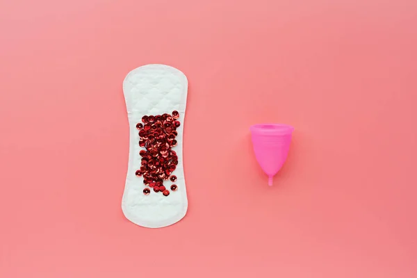 Taza menstrual, compresa sanitaria sobre fondo rosa. Producto alternativo de higiene femenina durante el período. Concepto de salud de las mujeres. Copiar espacio. Concepto ecológico, cero productos de desecho. Plancha plana, maqueta, te — Foto de Stock