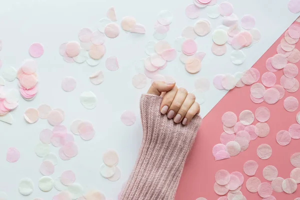 Elegante manicura rosa femenina de moda. Hermosa mano de mujer joven sobre fondo rosa y blanco con flores y lugar para el texto. Concepto creativo mínimo. Plano de laicos, vista superior, maqueta de copia plantilla de espacio — Foto de Stock