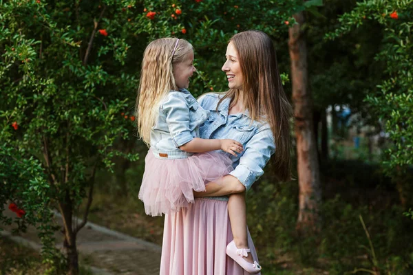 美しい女性と女の子の屋外の肖像画 花が咲く夏の公園で彼女の美しい母親と小さな娘 幸せな母親の日のコンセプト 高品質の写真 — ストック写真