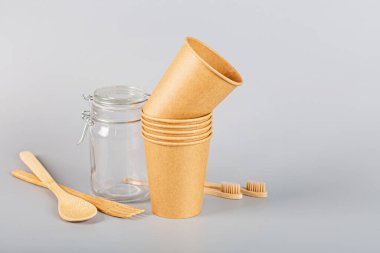 Gri arka planda ekolojik doğal kağıt bardaklar. Sürdürülebilir yaşam tarzı kavramı. sıfır atık, plastiksiz eşyalar. Plastik kirliliğini durdurun. Uzayı kopyala, şablon, Mockup. Yüksek kalite fotoğraf