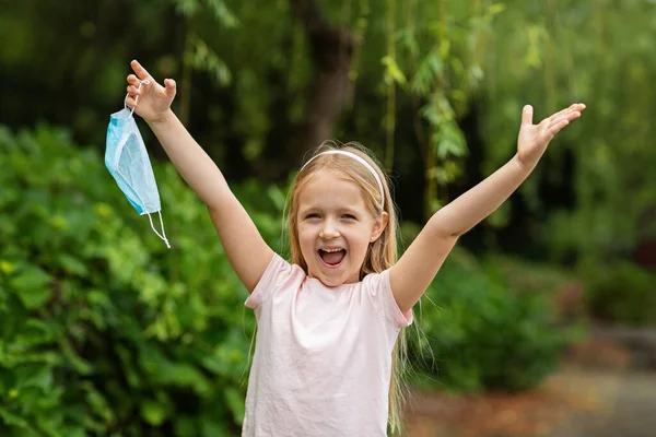 Happy Little Girl Takes Protective Medical Mask Face Outdoors Victory — Stock Photo, Image