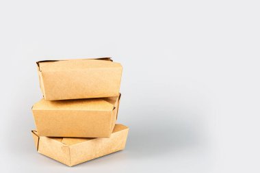 Gri arka planda yiyecek için kağıt kaplar. Yemek dağıtım servisi. Coronavirus covid-19 salgını sırasında yiyecekleri almak, boş karton karton paket. Kopyalama alanı olan uzun web pankartı