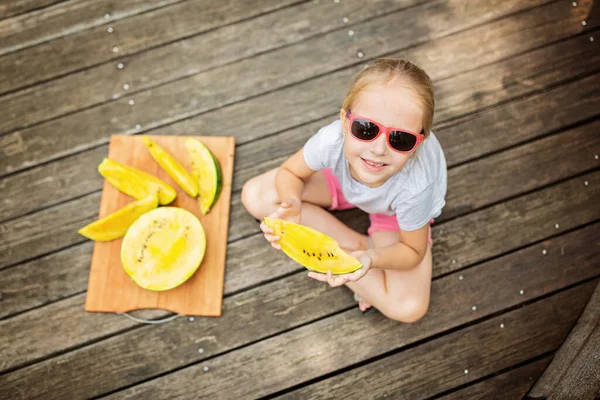 Happy Blonde Little Girl Sitting Outdoor Wooden Bridge Eating Yellow — Stock Photo, Image