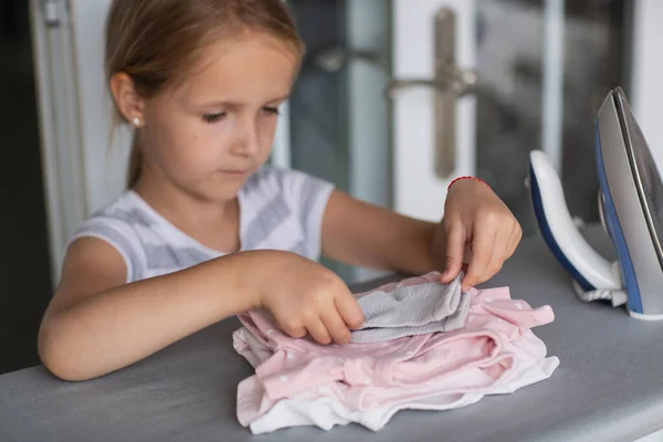 Carina Bambina Con Capelli Biondi Appoggia Vestiti Stiro Bordo Casa — Foto Stock