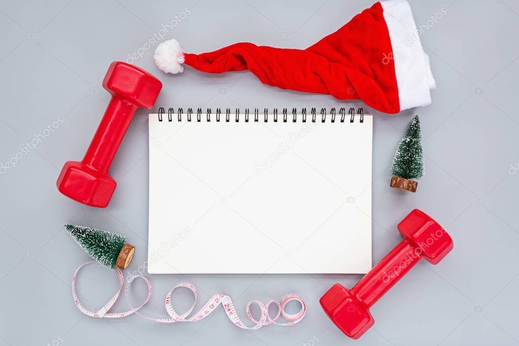 Exercise, Fitness and Working Out Merry Christmas and Happy new year concept. Sports equipment on gray background with copy space. Top view, overhead, mockup. High quality photo