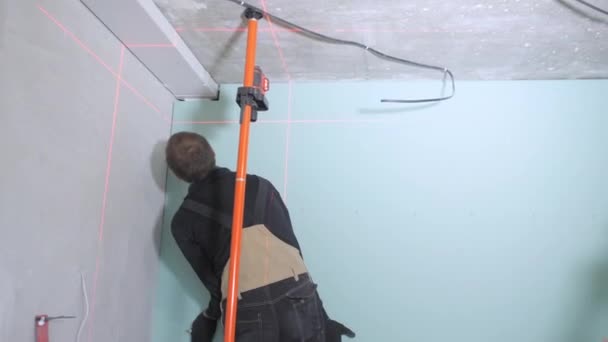 Experienced Handyman Black Brown Jumpsuit Fixes Blue Plasterboard Wall Ceiling — Stock Video