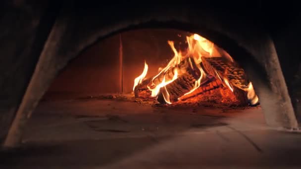 Fire flame covers chopped firewood pile heating oven — Stock Video