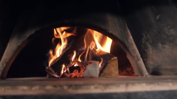 Wood logs burn in firebox with fire flame heating oven — Stock Video