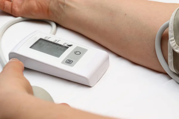 Medición de la presión arterial con un tonómetro. Brazalete para aire, pera para inflado, conexión de tubos de goma blanda . — Foto de Stock