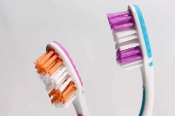 Toothbrushes and toothpaste on a mirror shelf. Oral hygiene products. — Stock Photo, Image