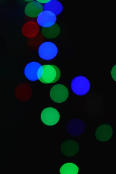 Lumières colorées (guirlande) dans l'obscurité. Effet Bokeh Eclairage festif . — Photo