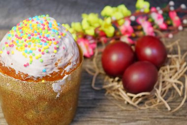 Beyaz sır paskalya pastası ve renkli tatlı topları serpme. Boyalı Paskalya yumurtaları.