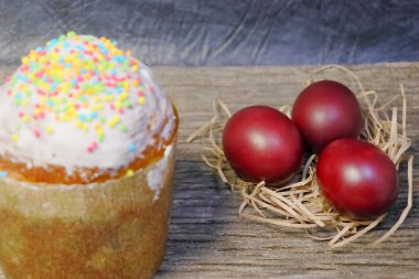 Beyaz sır paskalya pastası ve renkli tatlı topları serpme. Boyalı Paskalya yumurtaları.