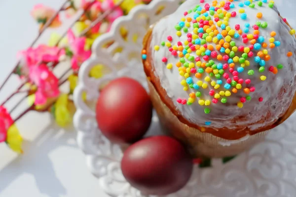 Beyaz sır paskalya pastası ve renkli tatlı topları serpme. Boyalı Paskalya yumurtaları. — Stok fotoğraf
