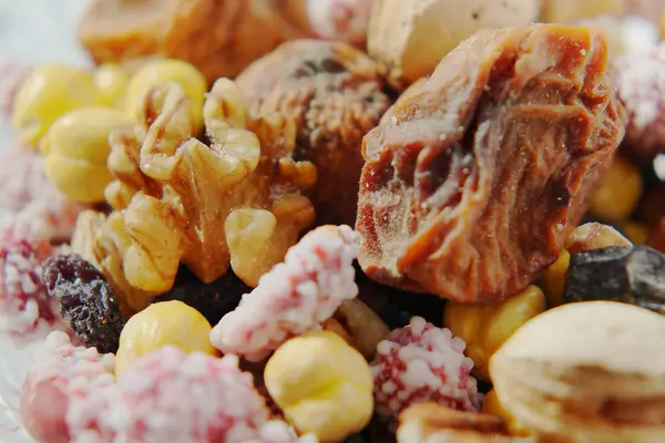 Sweet dried fruits and nuts in a crystal vase. — Stock Photo, Image