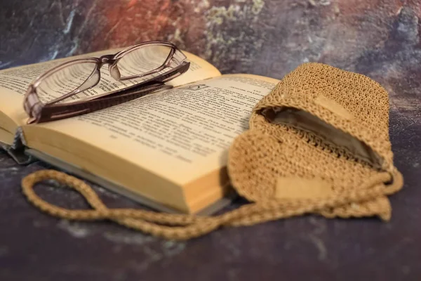 Old books, yellowed from time to time, glasses in a knitted yellow thread. — Stock Photo, Image