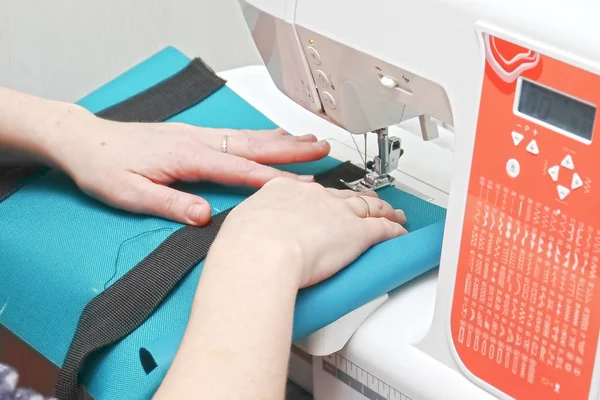 Seamstress at work on a sewing machine.